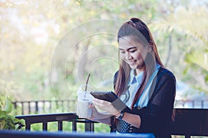 Young woman using tablet in coffee shop