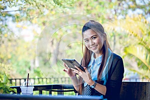 Young woman using tablet in coffee shop