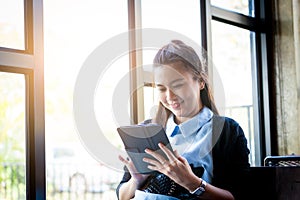 Young woman using tablet in coffee shop
