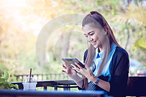 Young woman using tablet in coffee shop