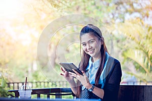 Young woman using tablet in coffee shop