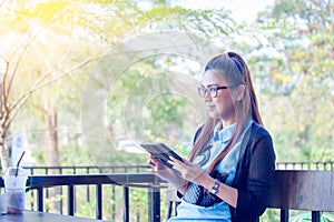 Young woman using tablet in coffee shop