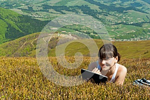 Young woman using tablet computer outdoors