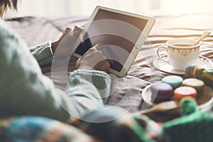 Young woman using tablet at cozy home atmosphere