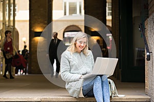 Young woman using tablet, laptop & mobile phone at the shopping