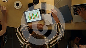 Young woman using tablet in office. Colleagues working together indoors.