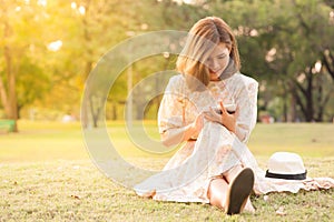 Young woman using tablet in park