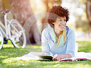 Young woman using tablet in the park.