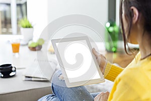 Young woman using tablet pc at home