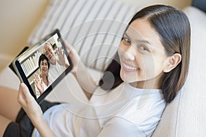 young woman is using tablet to Video calling or Webcam to grandparent ,  telecommunications technology , parenthood family