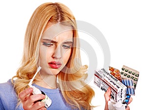 Young woman using throat spray.