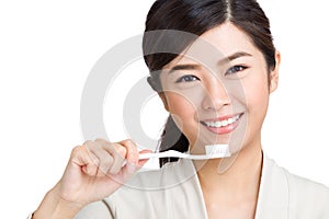 Young woman using toothbrush