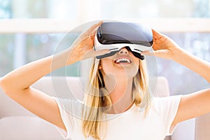 Young woman using virtual reality headset