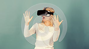 Young woman using a virtual reality headset with conceptual network lines. Amazed young woman touching the air during