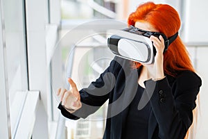 Young woman using virtual reality headset at technology exhibition
