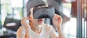 Young woman using virtual reality headset. VR, Future digital technology, game, entertainment, metaverse, NFT and 3D cyberspace