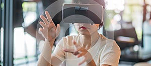 Young woman using virtual reality headset. VR, Future digital technology, game, entertainment, metaverse, NFT and 3D cyberspace