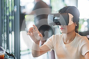 Young woman using virtual reality headset. VR, Future digital technology, game, entertainment, metaverse, NFT and 3D cyberspace