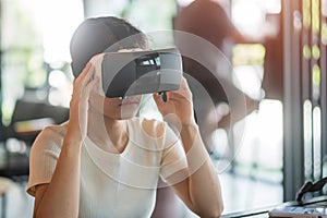 Young woman using virtual reality headset. VR, Future digital technology, game, entertainment, metaverse, NFT and 3D cyberspace