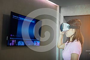 Young woman using virtual reality headset. VR, Future digital technology, game, movies entertainment, metaverse, NFT and 3D