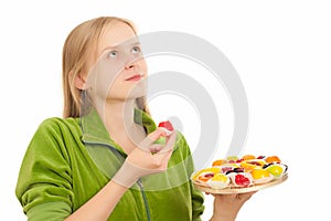 Young woman with variety of fruits and