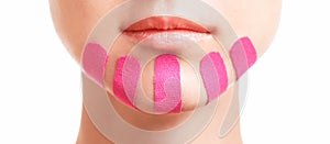 Woman with kinesio tapes on chin for facelift, close-up. photo