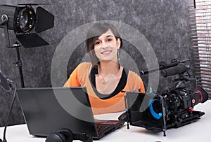 Young woman video editor working in studio