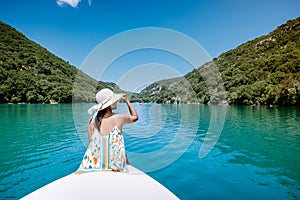 Young woman view to the cliffy rocks of Verdon Gorge at lake of Sainte Croix, Provence, France, near Moustiers Sainte