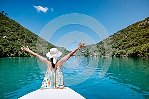 Young woman view to the cliffy rocks of Verdon Gorge at lake of Sainte Croix, Provence, France, near Moustiers Sainte