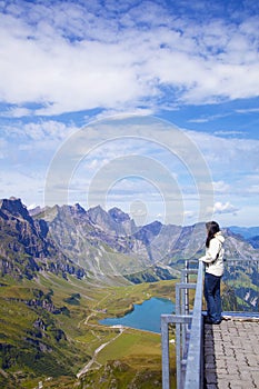 Young woman in a viewpoint of Swiss Alps