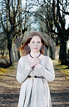 Young woman in vintage dress pray