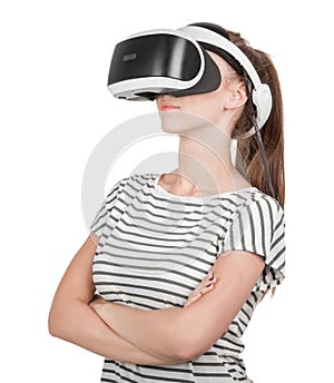 A young woman in virtual reality glasses enjoys his trip in an adventurous world, isolated on white background. Digital VR device.