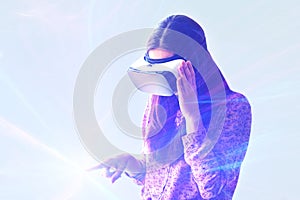 Young woman with virtual reality glasses. Modern technologies. The concept of future technology.