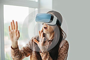 Young woman with virtual reality glasses. Modern technologies. The concept of future technology.