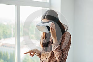 Young woman with virtual reality glasses. Modern technologies. The concept of future technology.