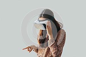 Young woman with virtual reality glasses. Modern technologies. The concept of future technology. The concept of a remote