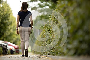 Young woman with vision impairment walking on city streets