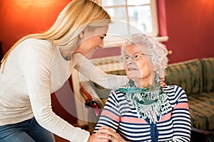 Young woman visit grandmother and support her about health