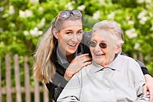 Young woman is visiting her grandmother in nursing home photo