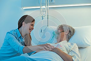 Young woman visiting her mother in hospital