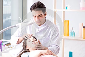 Young woman visiting male doctor cosmetologist