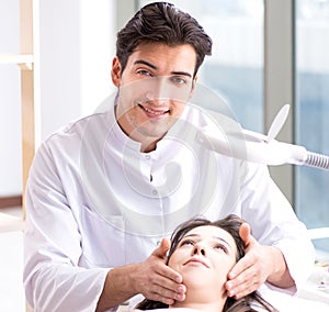 Young woman visiting male doctor cosmetologist