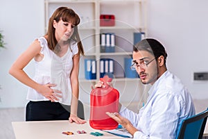 Young woman visiting male doctor gastroenterologist