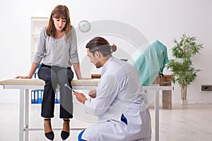 Young woman visiting male doctor neurologist photo