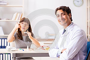 The young woman visiting male doctor ophthalmologist in hospital