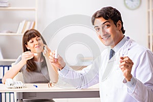 The young woman visiting male doctor ophthalmologist in hospital