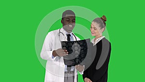 Young woman visiting radiologist for x-ray exam of her brain on a Green Screen, Chroma Key.