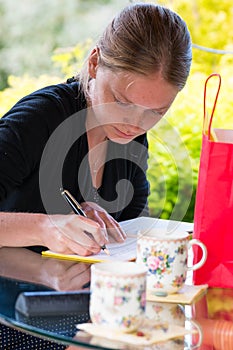 Young woman signing a guestbook
