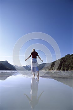 Young woman wading in lake