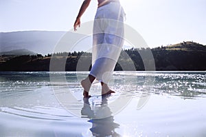 Young woman wading in lake